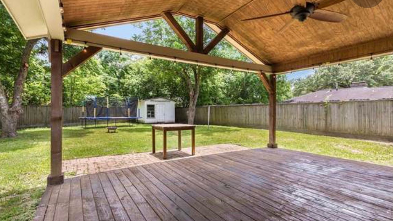 Wooden gable patio cover with ceiling fan