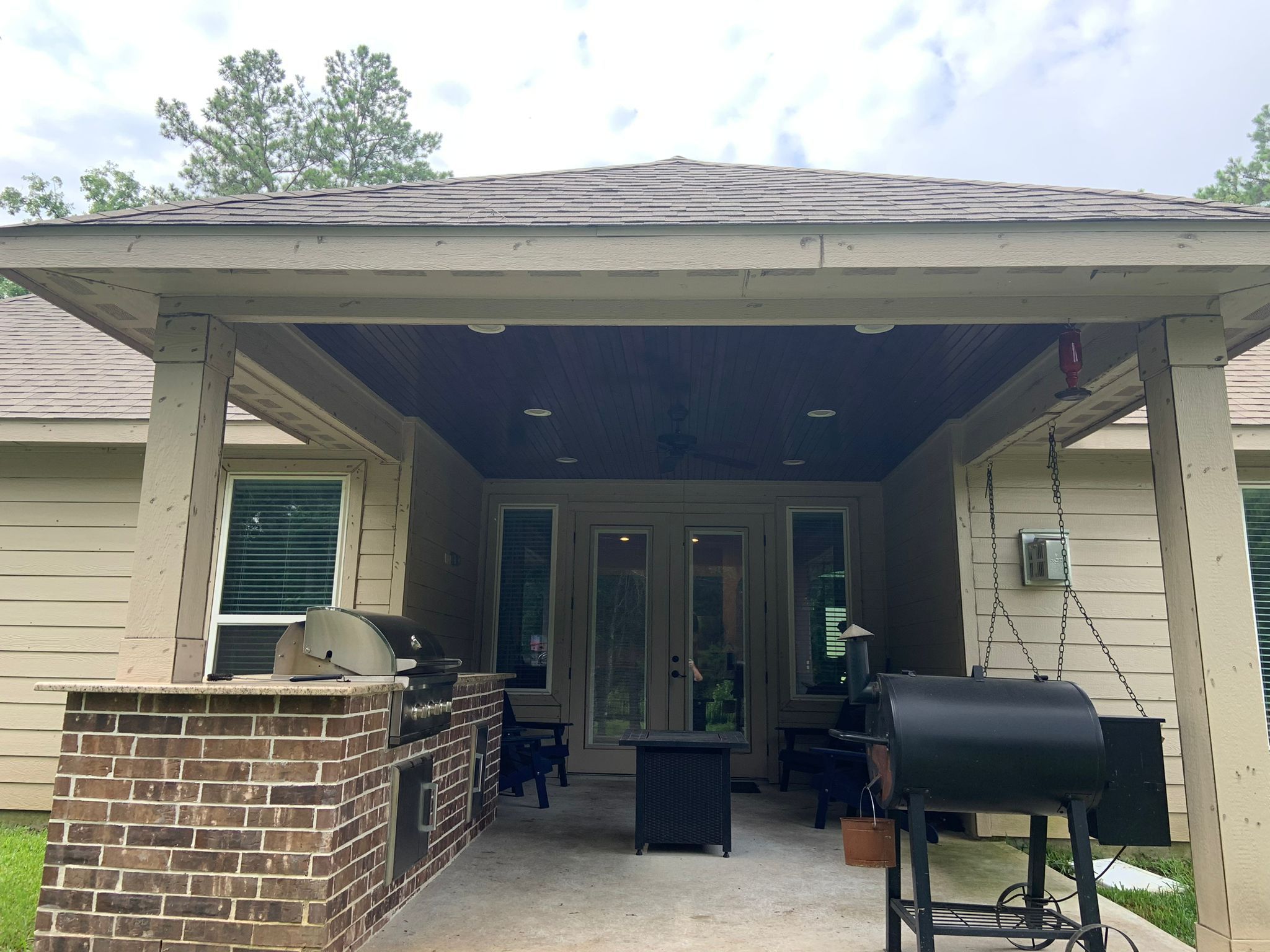 Covered patio with outdoor kitchen and grill